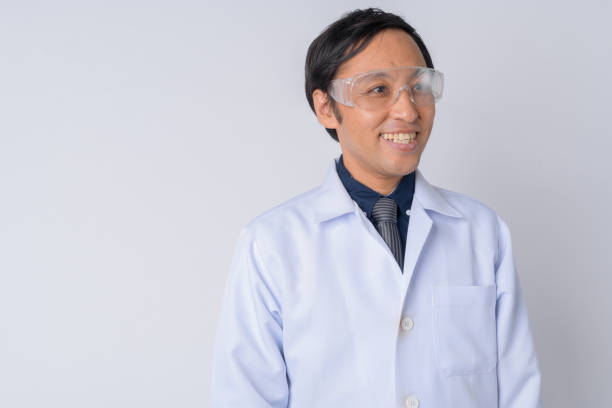 istock Happy Japanese man doctor wearing protective glasses thinking 1187325459