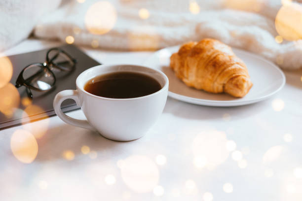 istock Coffee and croissant in bed 1187326731