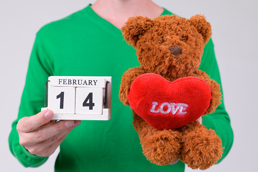 Studio shot of young handsome man ready for Valentine's day against white background