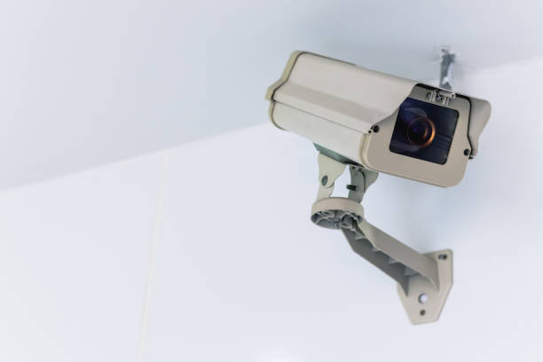 istock CCTV camera security technology system hang on the white wall with copy space. Equipment for observe, crime prevention and protect private safety and property. 1187327175