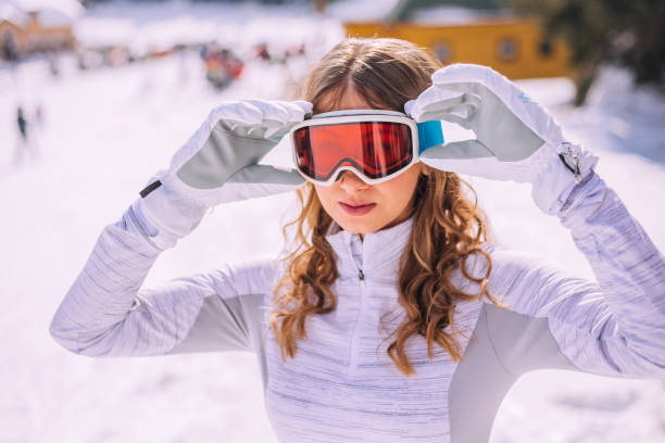 istock Young woman fixing her ski goggles 1187327859