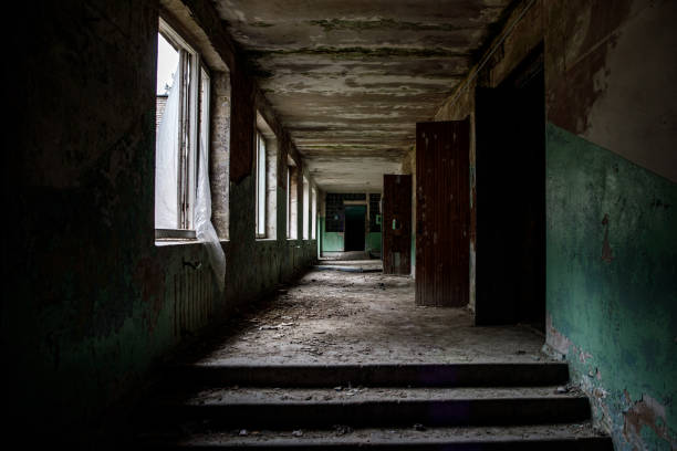 istock Ruined empty corridor in an abandoned building. 1187328420