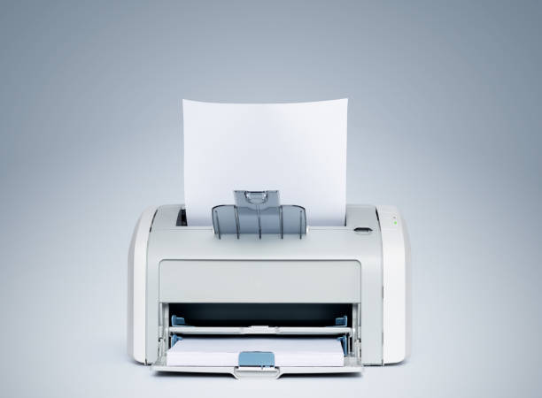 istock Laser printer with paper front view, on a light blue background. File contains a path to isolation. 1187328453