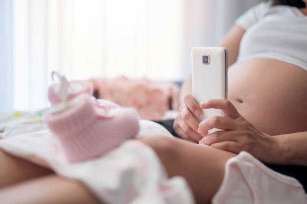 istock Baby clothes, taking photo 1187328752