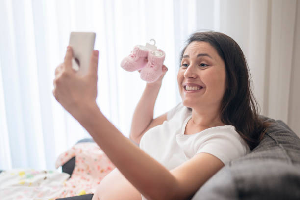 istock Baby clothes, taking photo 1187328755