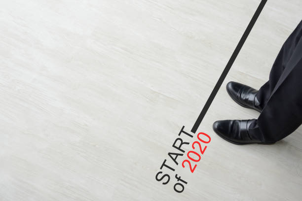 istock Business man standing on start line of 2020 1187329417