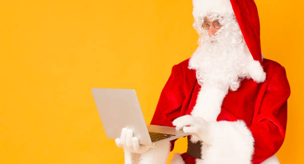 istock Santa Claus getting Christmas wishes through the Internet 1187330184