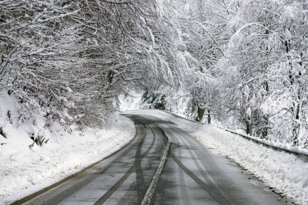 istock Empty road with snow banks on sides. 1187330221