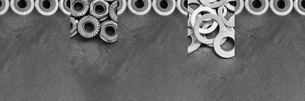 Fasteners collage. Horizontal long banner with different kinds of screws, rivet nuts. Black and white metal details. Modern technology, ingineering, industry. Close up.