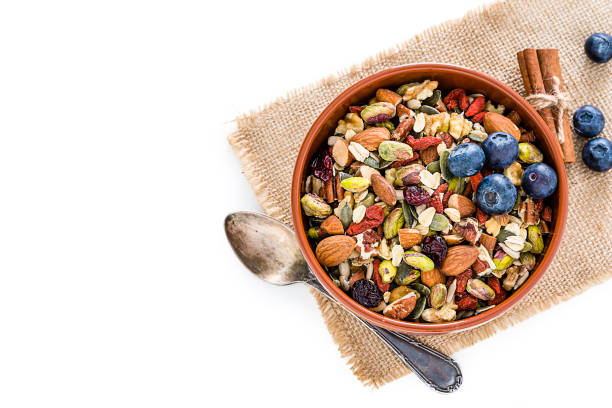 istock Healthy mixed nuts and seeds bowl on white background with copy space 1187334008