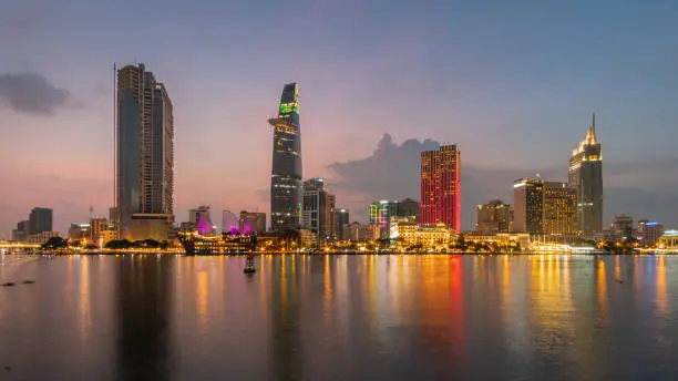 Photo of Saigon Cityscape at Sunrise. Skyline with cloudy sky, Modern City Skyline Riverside. ho chi minh , Vietnam.