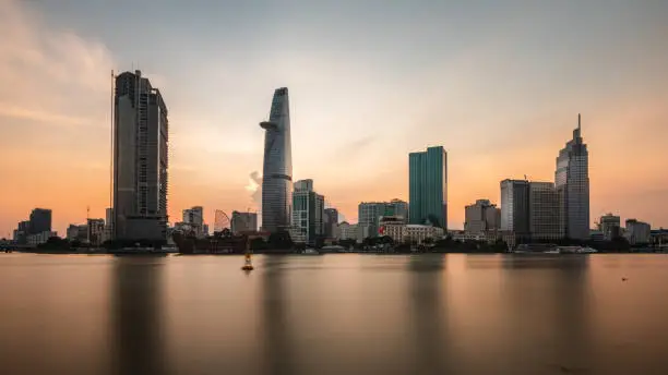 Photo of Saigon Cityscape at Sunrise. Skyline with cloudy sky, Modern City Skyline Riverside. ho chi minh , Vietnam.