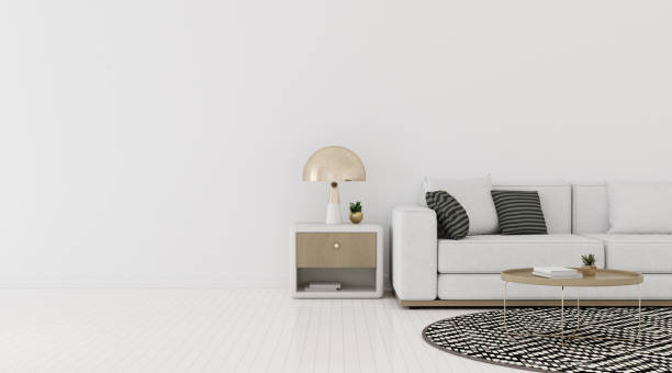 istock View of living room space with sofa and round side table on empty wall and bright laminate floor.Perspective of minimal interior design with gold lamp. 3d rendering. 1187335552