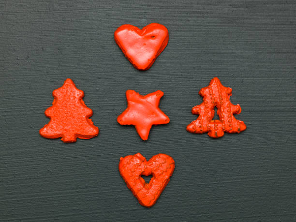 istock red christmas cookies on black background 1187335559