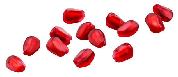 istock Falling pomegranate seeds isolated on white background with clipping path 1187335837