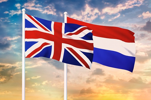 Relationship between the United Kingdom and the Netherlands. Two flags of countries on heaven with sunset. 3D rendered illustration.