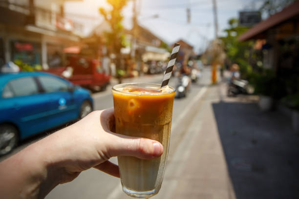 Iced coffee in a glass on a hot street. Iced coffee in a glass on a hot street freddo cappuccino stock pictures, royalty-free photos & images