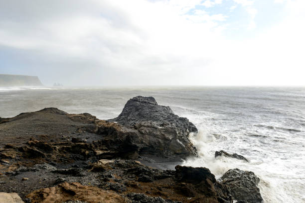 istock Storm clouds over Dyrholaey black basalt sand beach and cliffs 1187337693