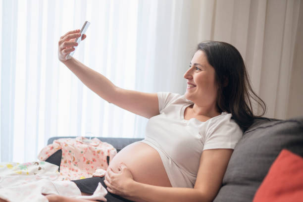 istock Baby clothes, taking photo 1187338676