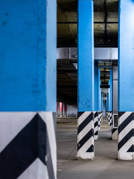 istock Columns in an empty underground parking at night in the light of artificial lighting. City infrastructure. 1187338886