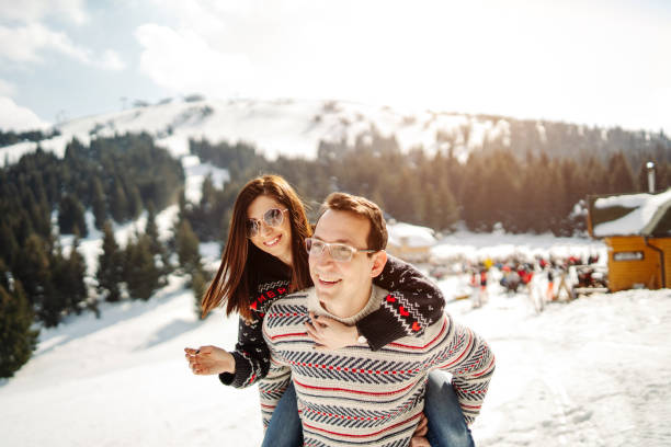 playful couple having fun on snow - snow glasses imagens e fotografias de stock