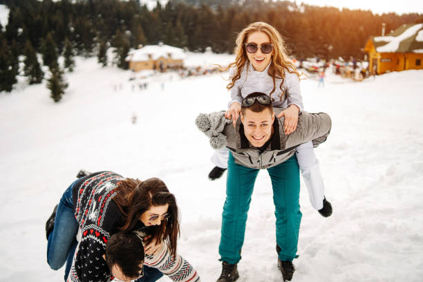istock Playful friends having fun on snow 1187340469