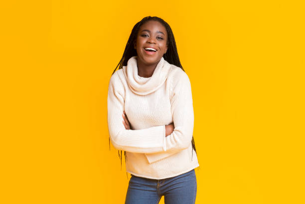 istock Successful afro girl laughing over yellow background 1187341345