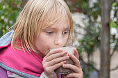Beautiful blond girl drinking hot chocolate