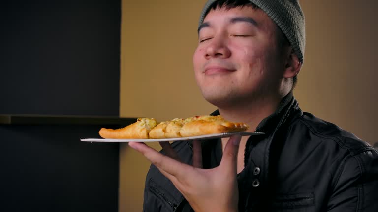 4K Footage Teenagers wear winter clothes, He is eating pizza That calls to order delivery