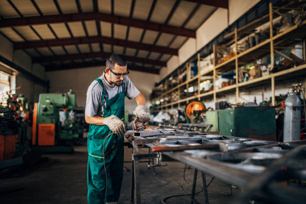 istock Young man working in metal factory 1187341861