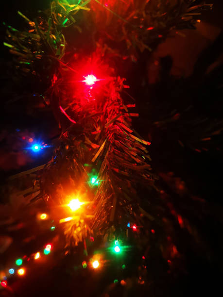 istock Christmas lights magically shining in the dark on a Christmas tree 1187343421