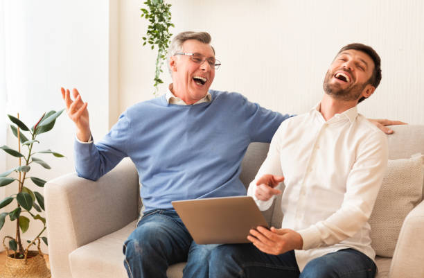 istock Middle-Aged Son And Senior Father Using Laptop Laughing At Home 1187343441