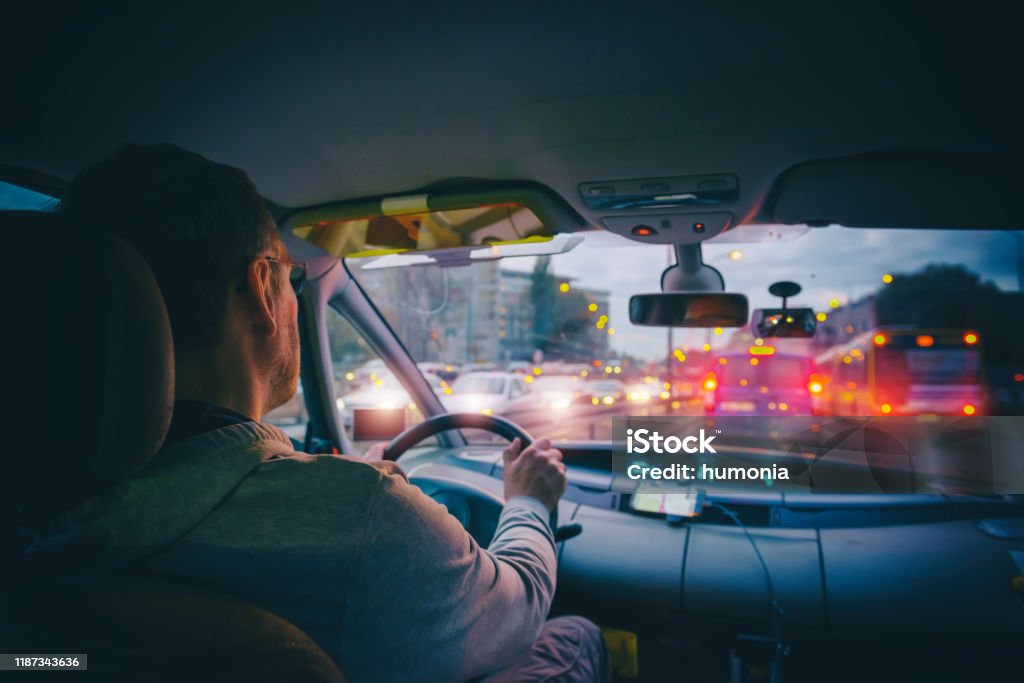 Driving a car in the city at night in traffic jams Driving a car in the city at night in traffic jams. A concept of a difficult return home Driving Stock Photo