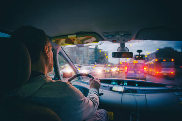 Driving a car in the city at night in traffic jams stock photo