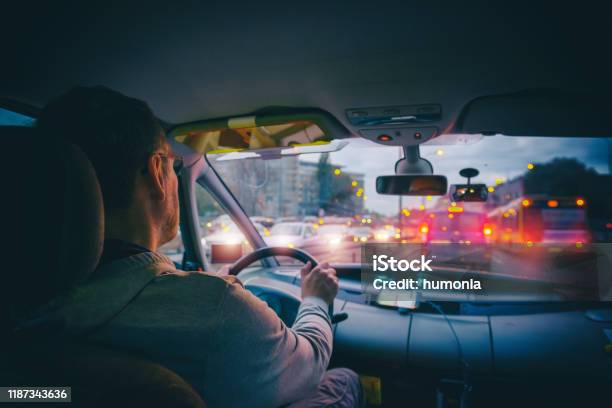 Driving A Car In The City At Night In Traffic Jams Stock Photo - Download Image Now - Driving, Driver - Occupation, Taxi Driver