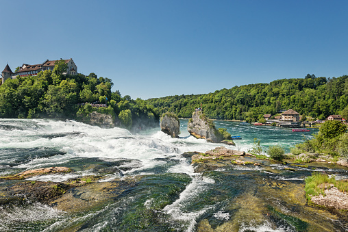 The Rhine Falls is one of the three largest waterfalls in Europe and an international landmark. It is located in Switzerland. Ideal for tourists: On extended paths you can reach viewing platforms on both sides of the Rhine.