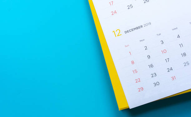 close up top view on white calendar December 2019 schedule on blue color background to make appointment meeting or manage timetable each day for design planning work and life concept