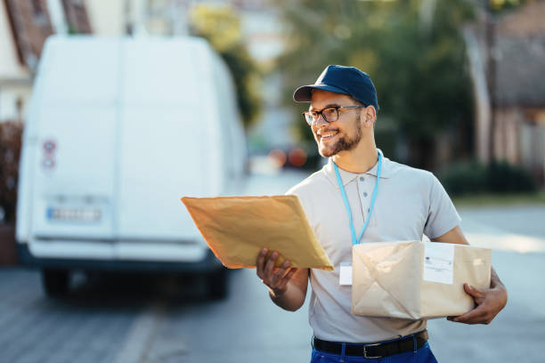 istock Young happy courier making a delivery in the city. 1187346881