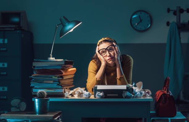istock Exhausted secretary working at night in the office 1187347809