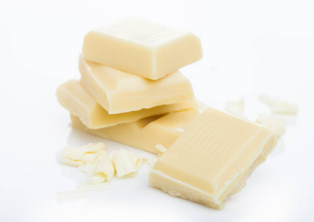 istock White chocolate pieces and curls isolated on white background 1187348098