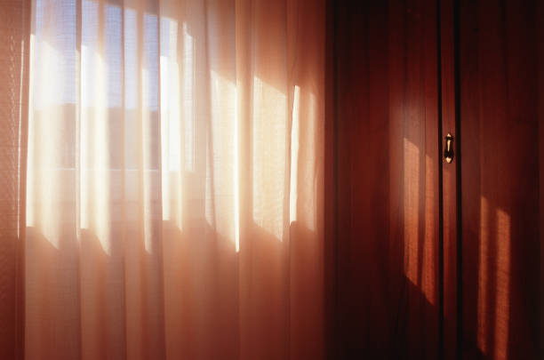 Room interiors and curtain, with beautiful light filtering through the curtain. Scan of Fujifilm Velvia 100 colour slide film