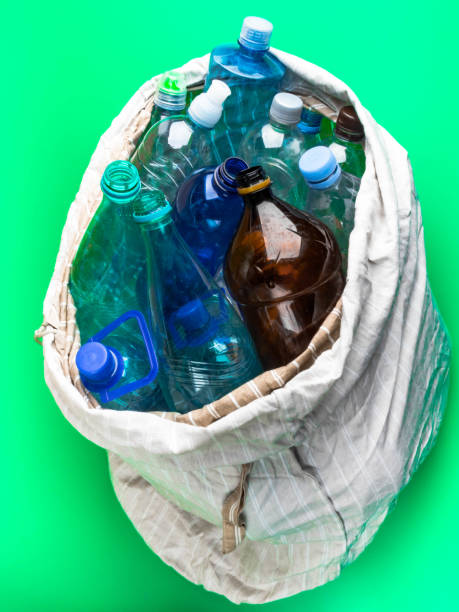 istock simple plastic bottles in a eco bag on a green background, recycling concept 1187348375