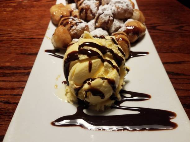 istock fried dough with powdered sugar and chocolate syrup and ice cream 1187349472