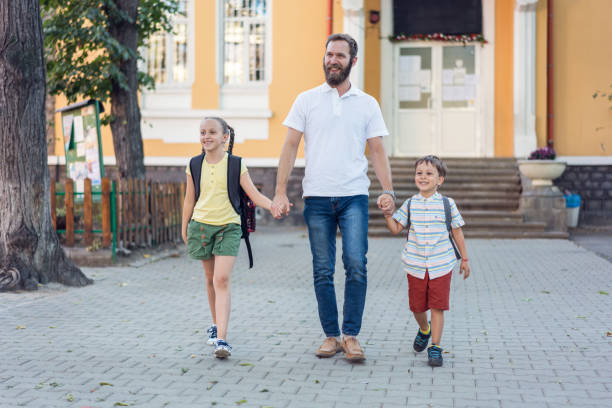 istock Father taking his kids from school 1187349672