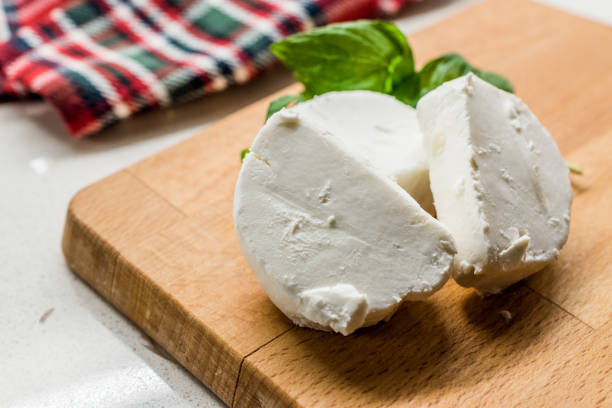 istock Goat Cheese Slices on Wooden Board. Ready to Eat. 1187349706