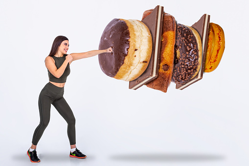 Fit young woman saying NO to sweets and candy, Fit young woman saying NO to unhealthy carbohydrates