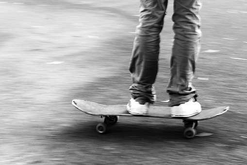detail of a quick movement of a boy on the skateboard, black and white photos