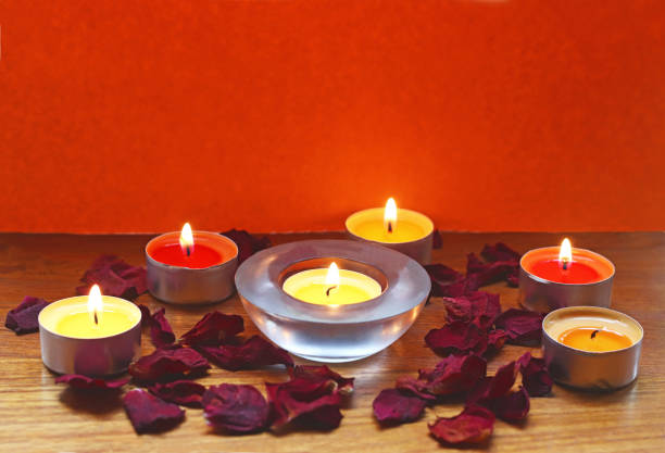 istock burning candles and dried rose petals 1187352401