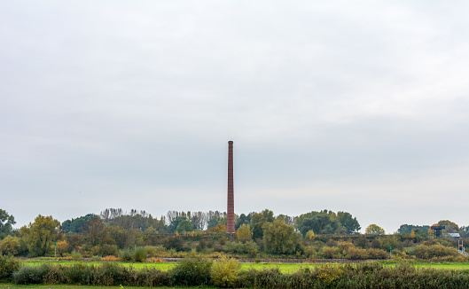 old stone factory in lush autumn colors with high chimney Nature Reserve Veessen duurse waarden