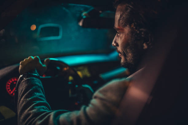 istock Gentleman driving a car at night 1187355147